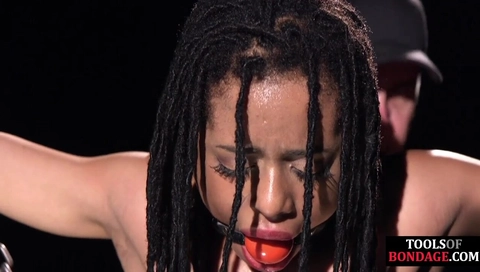Ebony ballgagged sub anallytoyed in BDSM suspension bondage